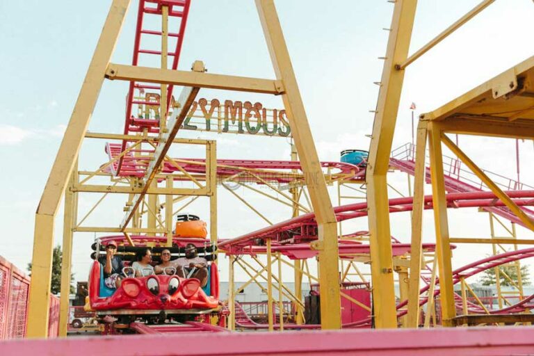 distance photo of family on mouse house ride at memphis tn fair even large coaster yellow and red for kids smiling 2022 danielle jacqueline photo