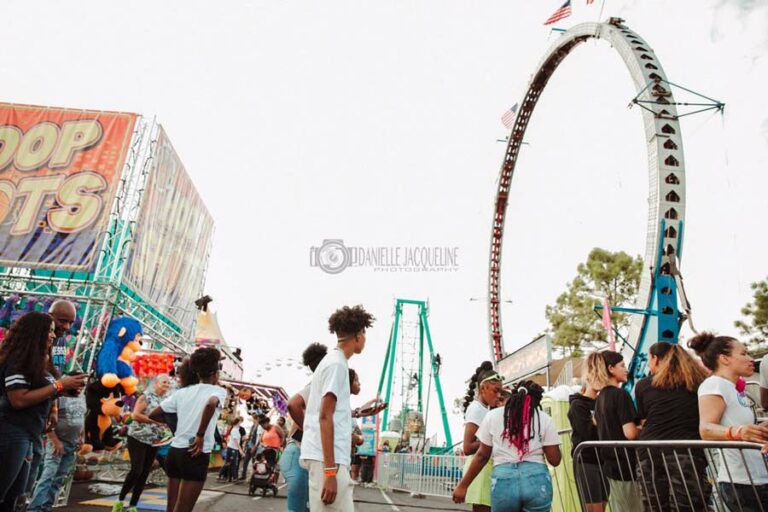 cool fair photography of walking path kids looking at rides enjoying themselves with ring of fire angled in the background cloudy skies 2022 danielle jacqueline memphis tn