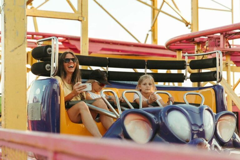 close up of mother and two children on roller coaster ride at midsouth fair during carnival event in 2022 photographer danielle jacqueline action shots