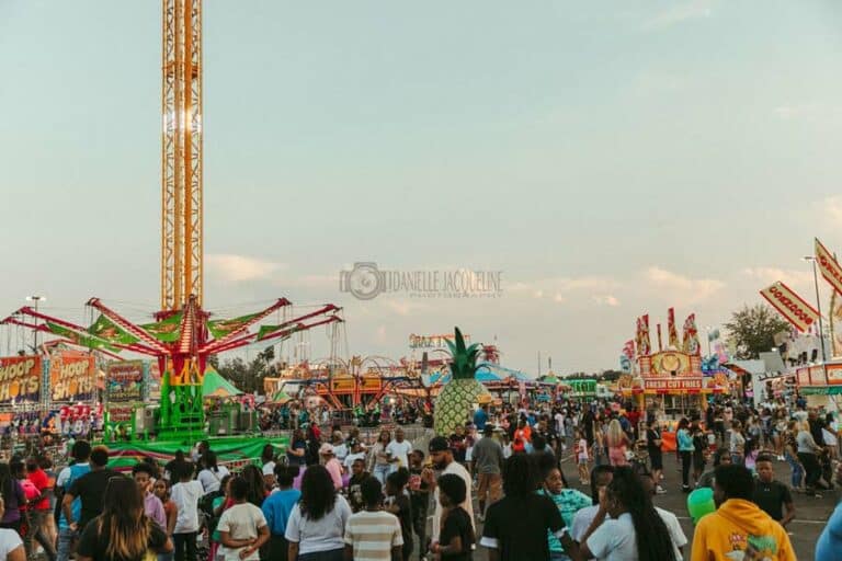 crowd shot at midsouth fair lights coming on dusk food vendors and tons of rides packed house in desoto county ms 2022 event photographer