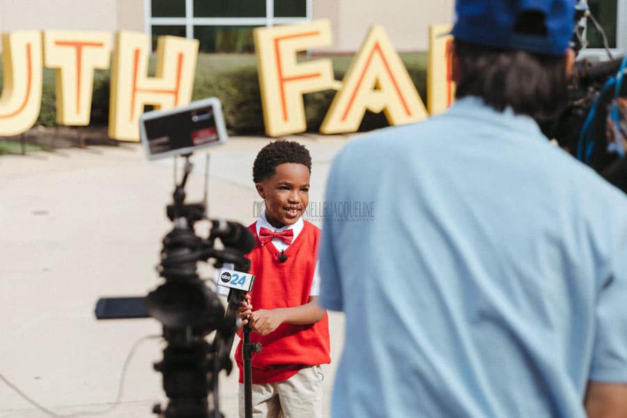 interviewing spokeskid by abc channel 24 in memphis for midsouth fair grand opening showcases sights and sounds by danielle jacqueline event photographer