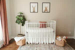 portrait of custom nursery made for first time parents captured by olive branch mississippi photographer during newborn home arrival session last spring bright white coral accent